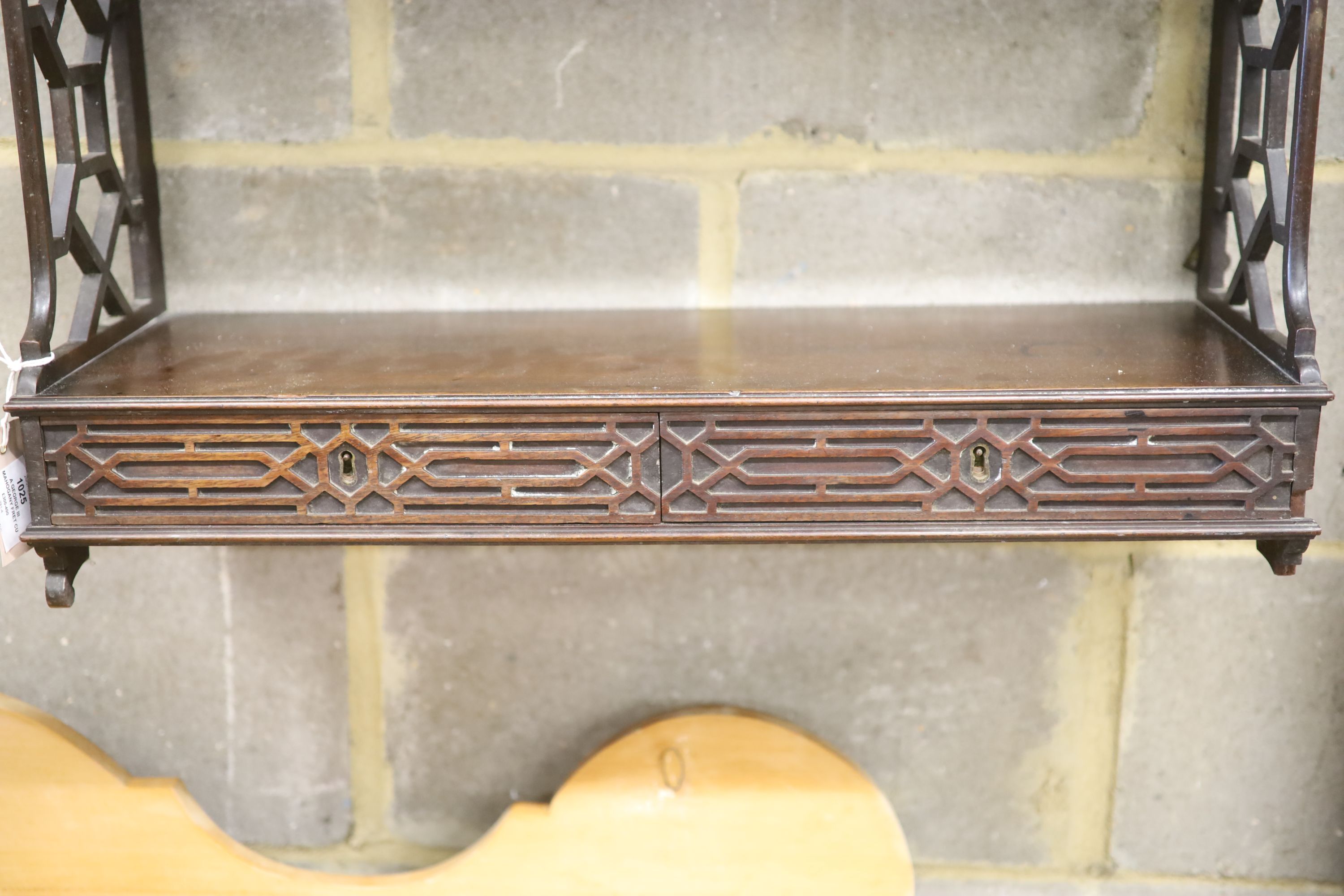 A George III mahogany fret cut four tier wall bracket, width 64cm, depth 22cm, height 94cm